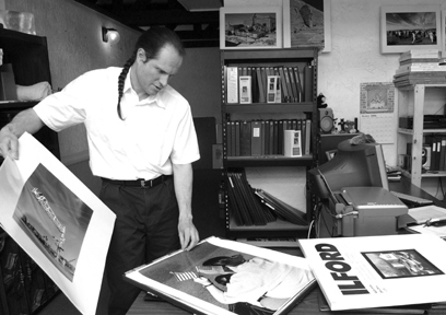 Nicholas Price looks through his black and white fine art prints